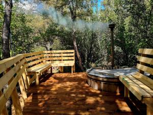 a wooden deck with two benches and a hot tub at Montblanc in Las Trancas