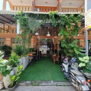 a store with plants and motorcycles parked in front of it at STAY SWEET in Phnom Penh