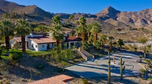 an aerial view of a house with palm trees and mountains at Big Horn Desert Estate Luxury Smarthome - Amazing Pool & Game Room! in Palm Desert