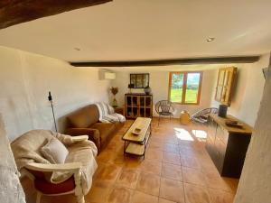 a living room with a couch and a table at BERGERIE PARADISU, Domaine de l Ogliastru in Olmeto