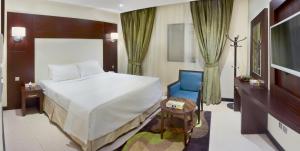 Кровать или кровати в номере Mina Concorde Hotel