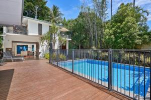 a fence around a swimming pool in a house at Onda Beach Clifton Beach in Clifton Beach