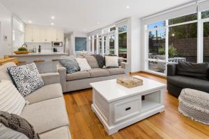 a living room with couches and a table at Sun Valley - Boutique Portsea Accommodation in Portsea