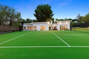 a house with a tennis court in front of it at Sun Valley - Boutique Portsea Accommodation in Portsea