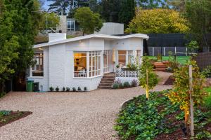 a white house with a gravel driveway at Sun Valley - Boutique Portsea Accommodation in Portsea