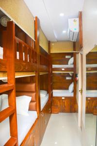 a room with four bunk beds in a boat at Hotel Nest N Rest - Mumbai in Mumbai