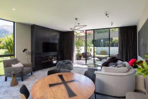 a living room with a table and chairs at Ivy Box Art Gallery Apartment in Queenstown