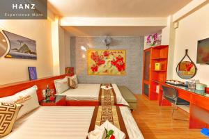 a hotel room with two beds and a desk at S79 Hotel Go Vap in Ho Chi Minh City