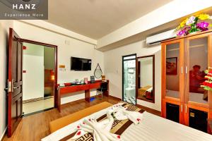 a hotel room with a bed and a tv at S79 Hotel Go Vap in Ho Chi Minh City +5 photos