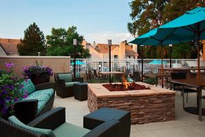 a patio with a fire pit and tables and chairs at Residence Inn by Marriott Boulder in Boulder