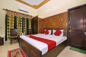 a bedroom with a large bed with red pillows at Morning Star in Mājra
