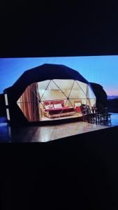 a side view mirror of a tent with tables and chairs at Wadi rum sand Delight camp in Wadi Rum