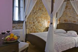 A bed or beds in a room at Klymeni Traditional Homes