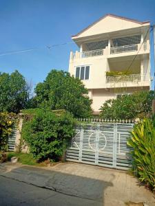 a white fence in front of a house at KOL House in Phnom Penh