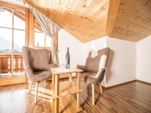 a dining room with two chairs and a table at Exquisite Apartment in Reith im Alpbachtal near Ski Resort and Lake in Reith im Alpbachtal