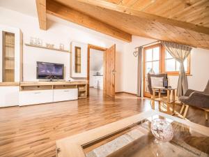 a large living room with wooden floors and a wooden ceiling at Exquisite Apartment in Reith im Alpbachtal near Ski Resort and Lake in Reith im Alpbachtal