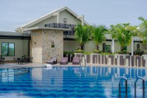 a resort with a swimming pool in front of a building at Grand City Hall Hotel & Serviced Residences in Medan