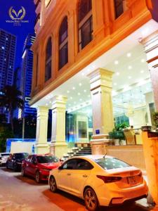 two cars parked in front of a building at Putin Hotel Nha Trang in Nha Trang