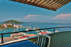 a balcony with a view of a harbor with boats at Apartments Novis - close to the sea in Kali