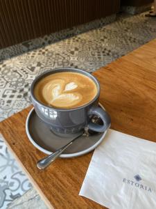 a cup of coffee sitting on top of a table at Airo Hotel Manila in Manila