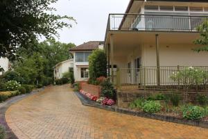 a house with a brick driveway in front of it at Leura Fairways East in Leura
