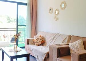 a living room with a couch and a table at Stunning View Boho Nova 3BR@KEA FARM, Brinchang, Cameron Highlands in Brinchang