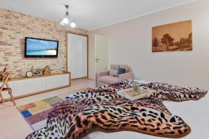 a bedroom with a bed and a tv on a brick wall at Bella Studio in Braşov