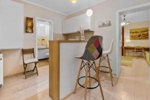 a kitchen with a counter and chairs in a room at Bella Studio in Braşov