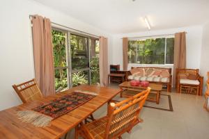 a living room with a wooden table and chairs at 35 Santa Monica Avenue in Coolum Beach