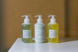 a group of three bottles of moisturizers on a shelf at W Osaka in Osaka