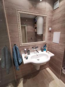 a bathroom with a sink and a mirror at Lily Beach - Apartment 408A in Sozopol