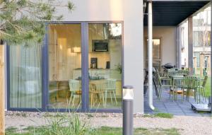 a house with sliding glass doors and a patio at Nice Apartment In Lembruchdümmer See in Lembruch