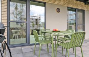 a green table and chairs on a patio at Nice Apartment In Lembruchdümmer See in Lembruch