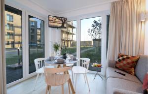 un soggiorno con tavolo, sedie e divano di Stunning Apartment In Lembruch-dmmer See With Kitchenette a Lembruch