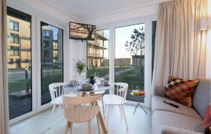 a living room with a table and chairs and a couch at Nice Apartment In Lembruchdümmer See in Lembruch +28 photos