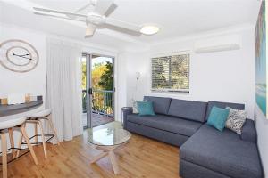 a living room with a couch and a table at Unit 13 Seacove Resort in Coolum Beach