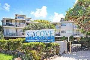 a sign for a seawookie resort in front of a building at Unit 13 Seacove Resort in Coolum Beach