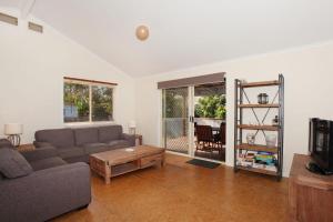 a living room with a couch and a coffee table at 24 Sundew Street in Mudjimba