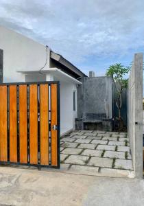 um portão em frente a uma casa branca em Davyn's House - Cozy and Private House in Lombok em Prampuan