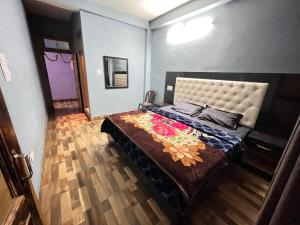 a bedroom with a large bed in a room at Shanti Cafe & Hostels in Kasol