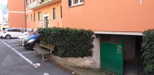 a bench in a parking lot next to a building at Sportrek House in Levanto