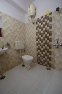 a bathroom with a toilet and a sink at Shreenath JI inn in Udaipur