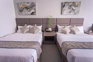 Postel nebo postele na pokoji v ubytování Anika Suites