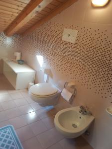 a bathroom with a toilet and a sink at B&B Piazzi di Katia in Caderzone Terme