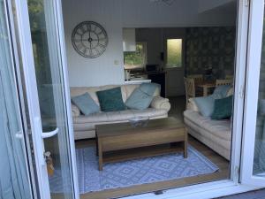 sala de estar con sofá y mesa de centro en CRIB GOCH HOLIDAY CABIN SNOWDONIA en Caernarfon
