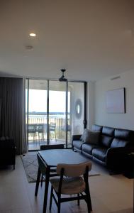 a living room with a couch and a table at RIVERVIEWS@THECOSMOPOLITAN UNIT20805 in Maroochydore