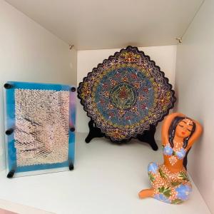 a mirror and a statue of a woman on a shelf at RIVIERA STUDIO CANNES CENTER in Cannes