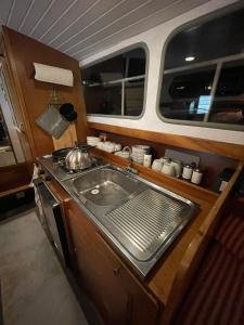 a kitchen with a sink and a stove at Motoryacht Bremen City in Bremen