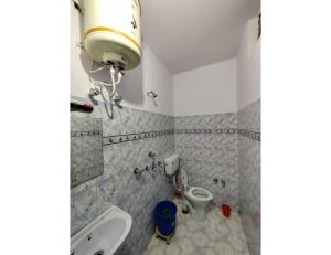 a bathroom with a sink and a toilet at Hotel Aastha, Uttarkashi in Uttarkāshi
