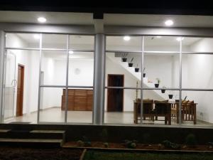 a view of a house with a table and a staircase at Panorama Holiday inn-Pelmadulla in Ratnapura